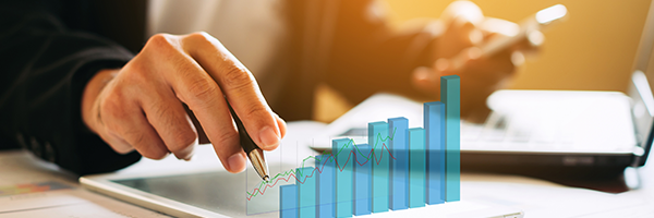 Person uses a tablet with a rising 3D bar chart overlay, suggesting data analytics and growth insights.
